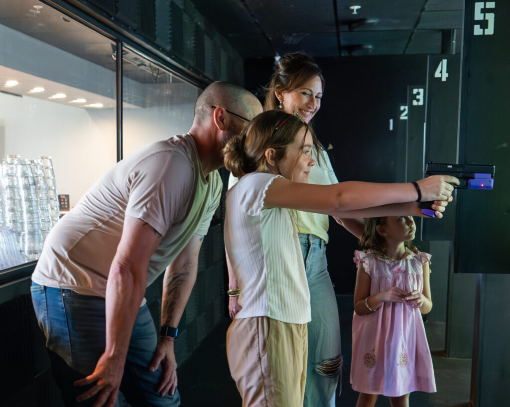 Shooting Range Experience | Decision Tactical Orlando - Decision Tactical | Indoor Theme Park Corporate group participant practicing shooting drills at Decision Tactical's shooting range in Sanford, Orlando Florida — a safe, captain-led experience with no live projectiles