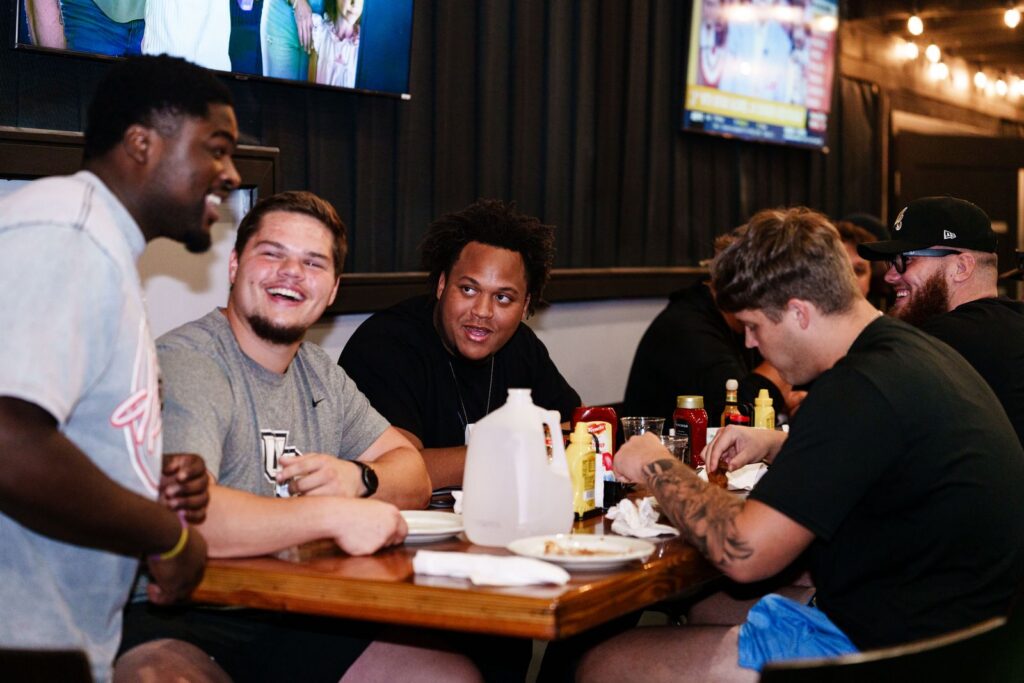 UCF Knights Football players enjoying catered food in the Rec Room at Decision Tactical in North Orlando